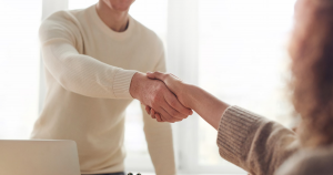Person getting hired by shaking hands with boss